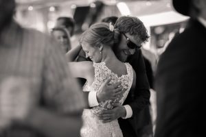 candid wedding photo of bride and groom dancing