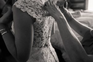 bride getting ready for ceremony in lace wedding gown
