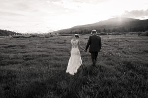 bride and groom in meadow with tetons for jackson hole wedding