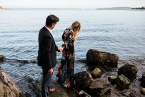 woman walks into water during engagement session at manchester state park