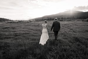 black and white images of a bride and groom walking into the sunset during their wedding in jackson hole