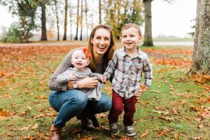 fall family photos of a mother and her two children at discovery park in seattle