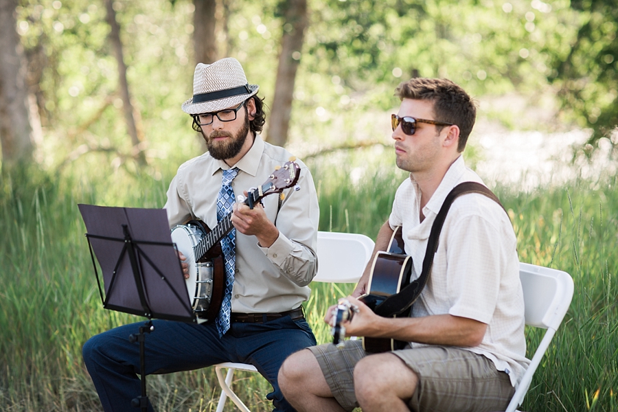 two men play acoustic guitar at a wedding in twisp