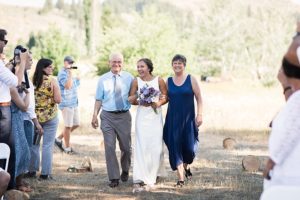bride walks down the aisle during backyard wedding in the methow valley