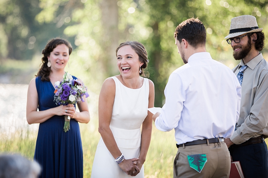 bride laughs during casual backyard wedding ceremony