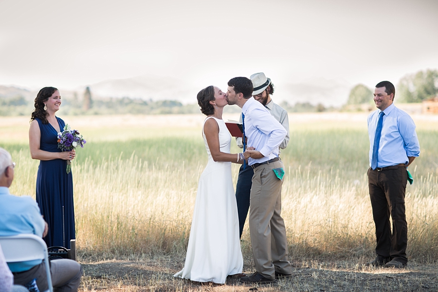 bride and groom kiss during casual wedding ceremony in the methow valley