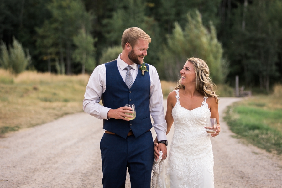 couple toasting champagne at their linn canyon ranch wedding in victor, idaho