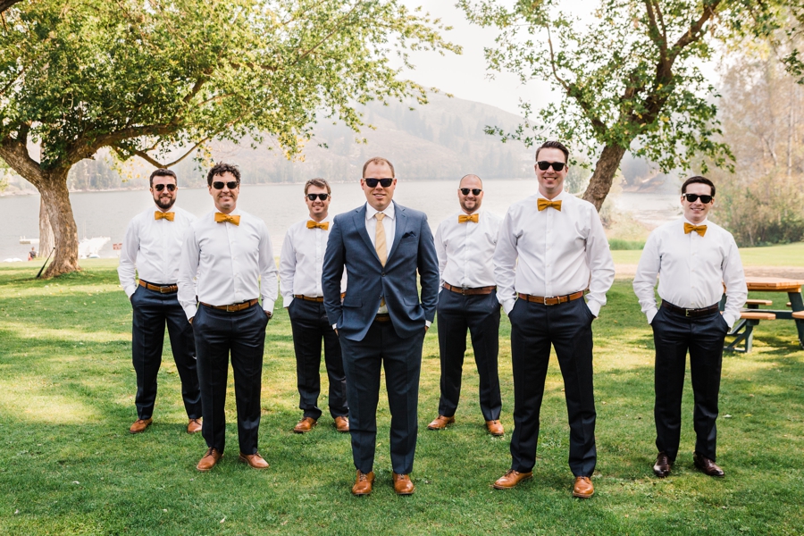 Groomsmen in yellow bowties and groom in navy suit at Sun Mountain Lodge wedding photographed by Amy Galbraith