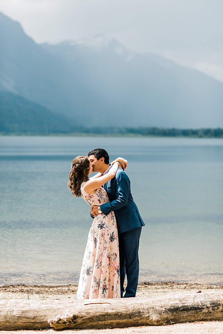 A couple gets married on a sunny spring day in Leavenworth, Washington. The bride is wearing a pink floral wedding gown.