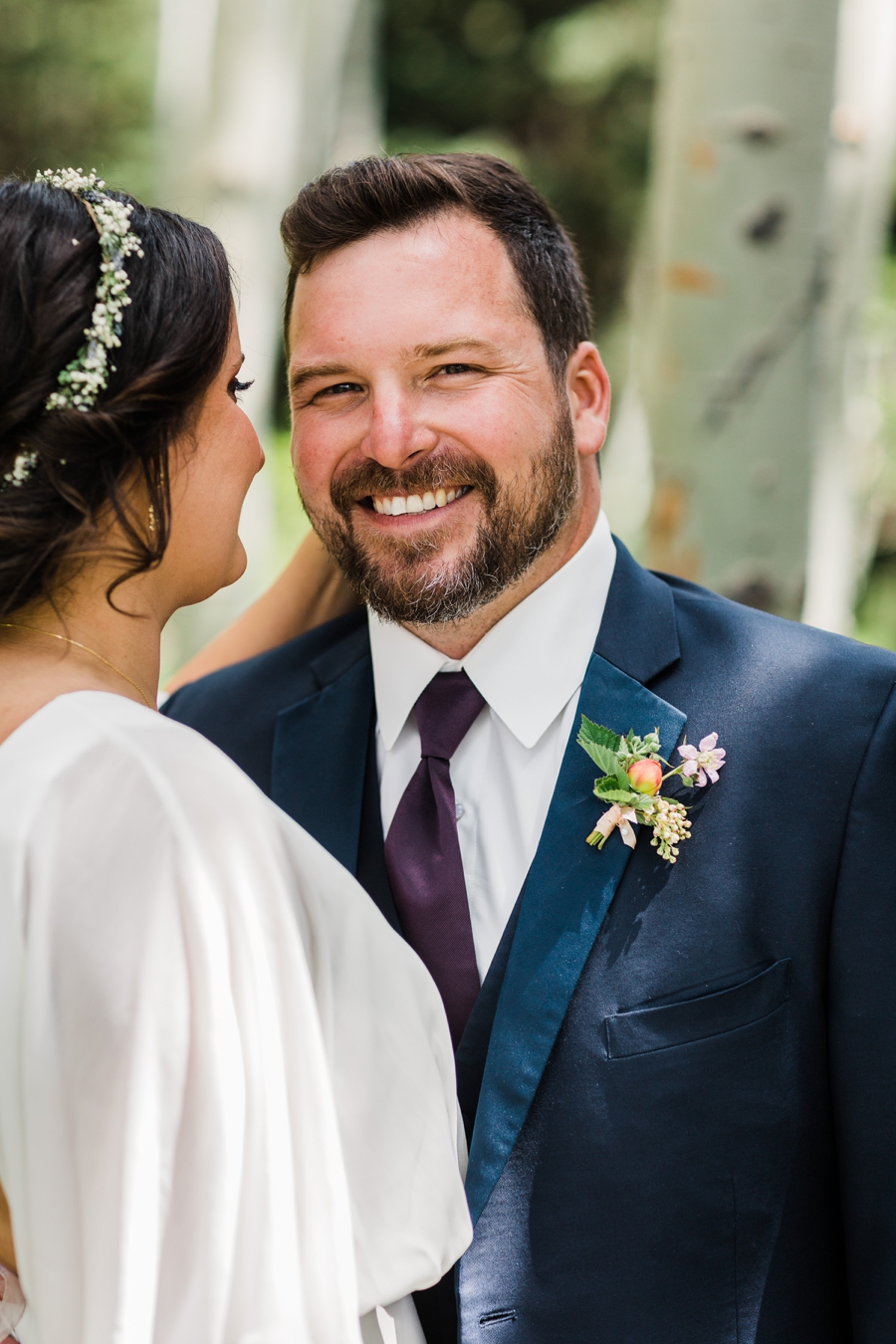 Groom smiling with his bride at his Jackson Hole wedding at Grand Targhee Resort by Amy Galbraith