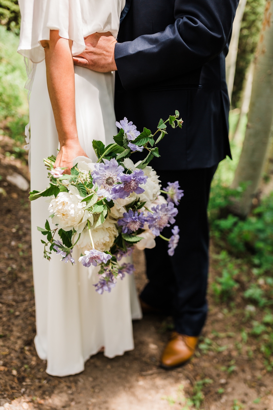 Purple and ivory bridal bouquet at Grand Targhee Resort by Jackson Hole wedding photographer Amy Galbraith