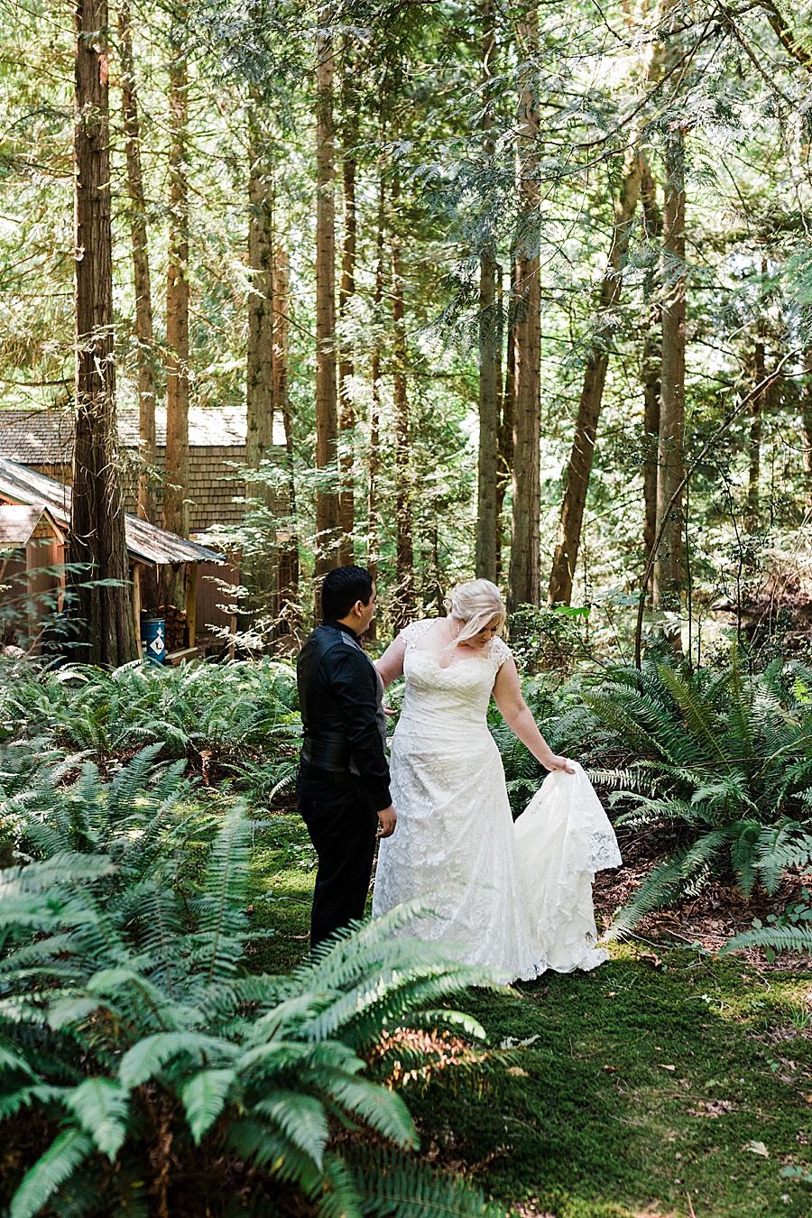 A couple poses for photos in the forest at their wedding in the woods by mountain wedding photographer Amy Galbraith