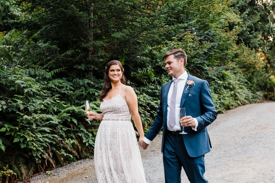 A bride and groom pose for photos on a hot summer day during their wedding at Green Gates at Flowing Lake by Seattle wedding photographer Amy Galbraith