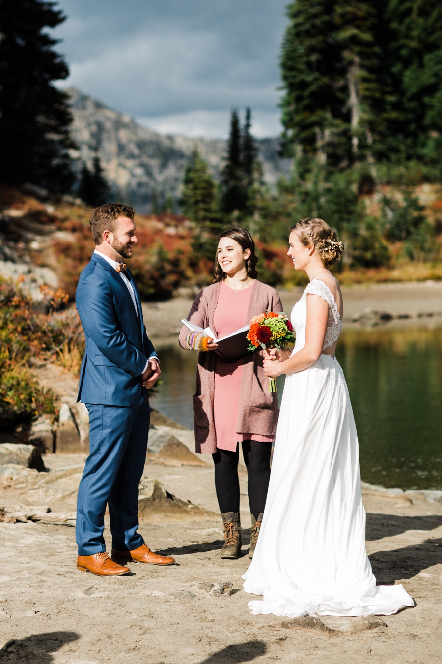 A bride and groom have a hiking wedding ceremony next to an alpine lake along the Pacific Crest Trail. Photographed by adventure wedding photographer Amy Galbraith.