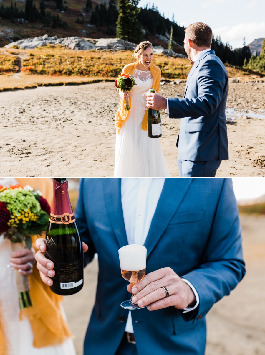 A bride and groom toast champagne near an alpine lake along the Pacific Crest Trail on their elopement day. Photographed by adventure elopement photographer Amy Galbraith.