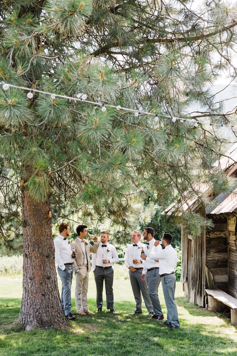 Groom and groomsmen sharing a drink before a wedding at Brown Family Homestead