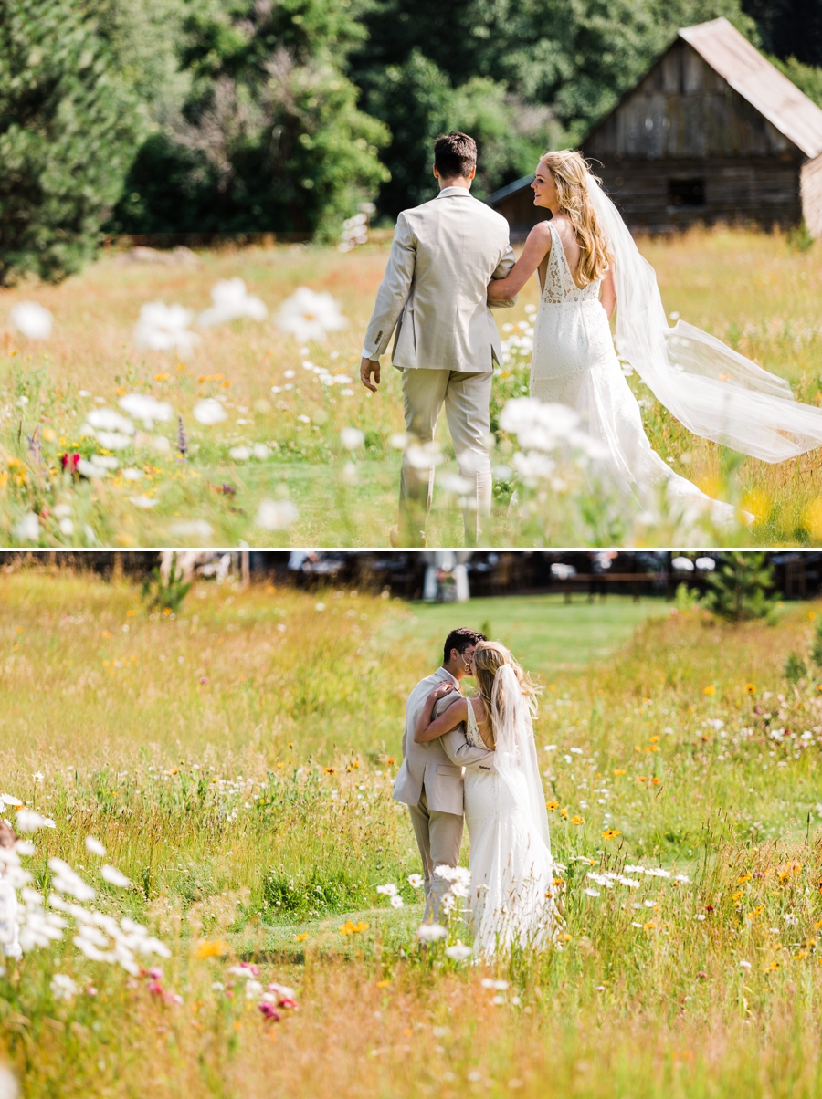 A bride and groom walk through fields of wildflowers after their wedding ceremony in Leavenworth