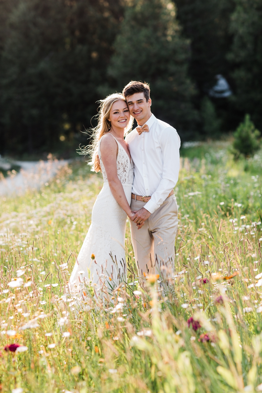 A bride and groom stand in a field of wildflowers at Brown Family Homestead in Leavenworth, Washington