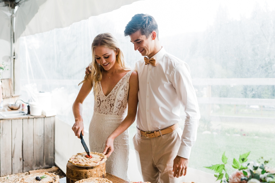 A bride and groom cut the pie at their mountain wedding in Leavenworth
