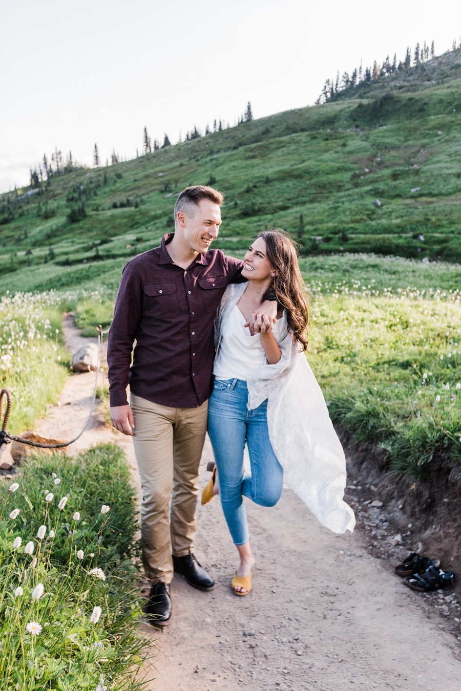 A couple strolls along a trail during their Mt Rainier engagement session with adventure wedding photographer Amy Galbraith