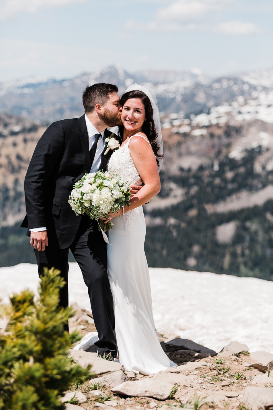 A bride and groom take photos with mountain wedding photographer Amy Galbraith at Grand Targhee Resort