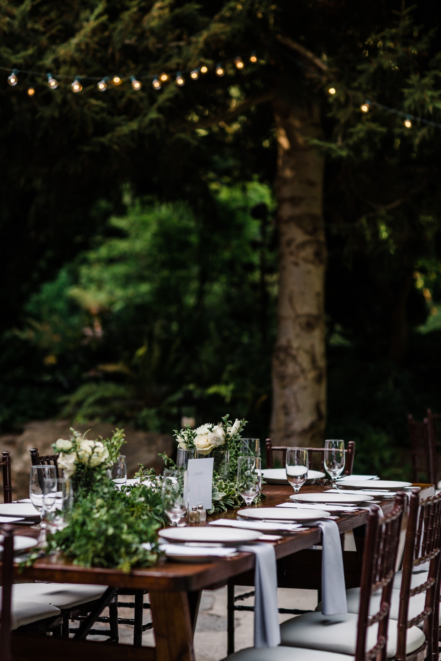 Rented wedding decor and long wooden tables for an eco-friendly wedding at JM Cellars photographed by Seattle wedding photographer Amy Galbraith