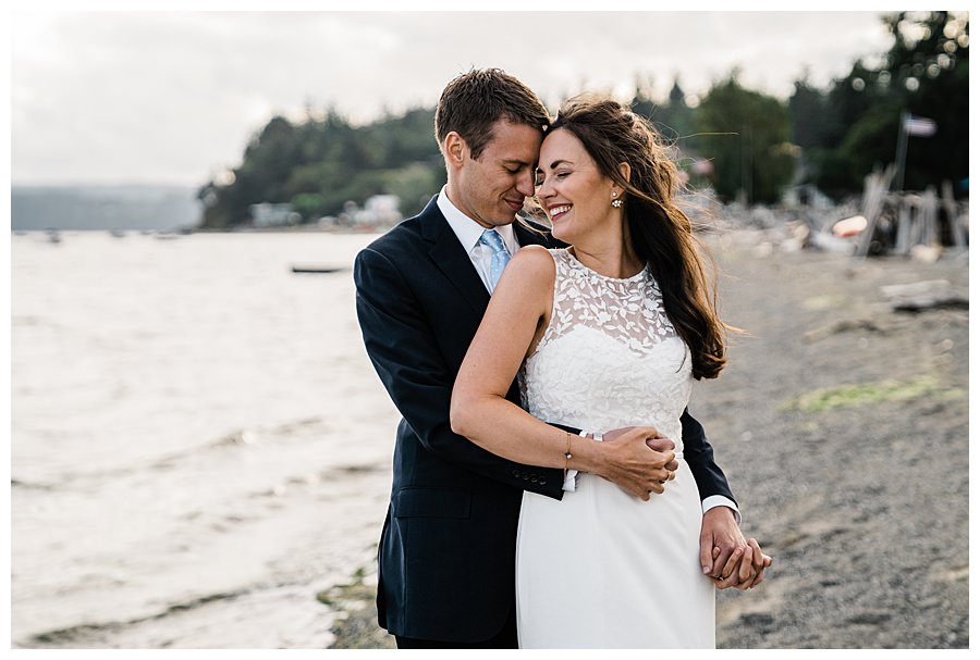 Bride and groom snuggle together during their Camano Island elopement photographed by Amy Galbraith