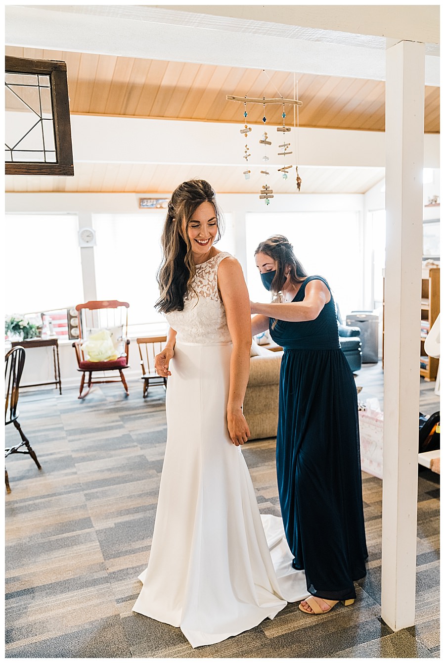 Bride gets ready in a beach house before her Camano Island elopement photographed by Amy Galbraith