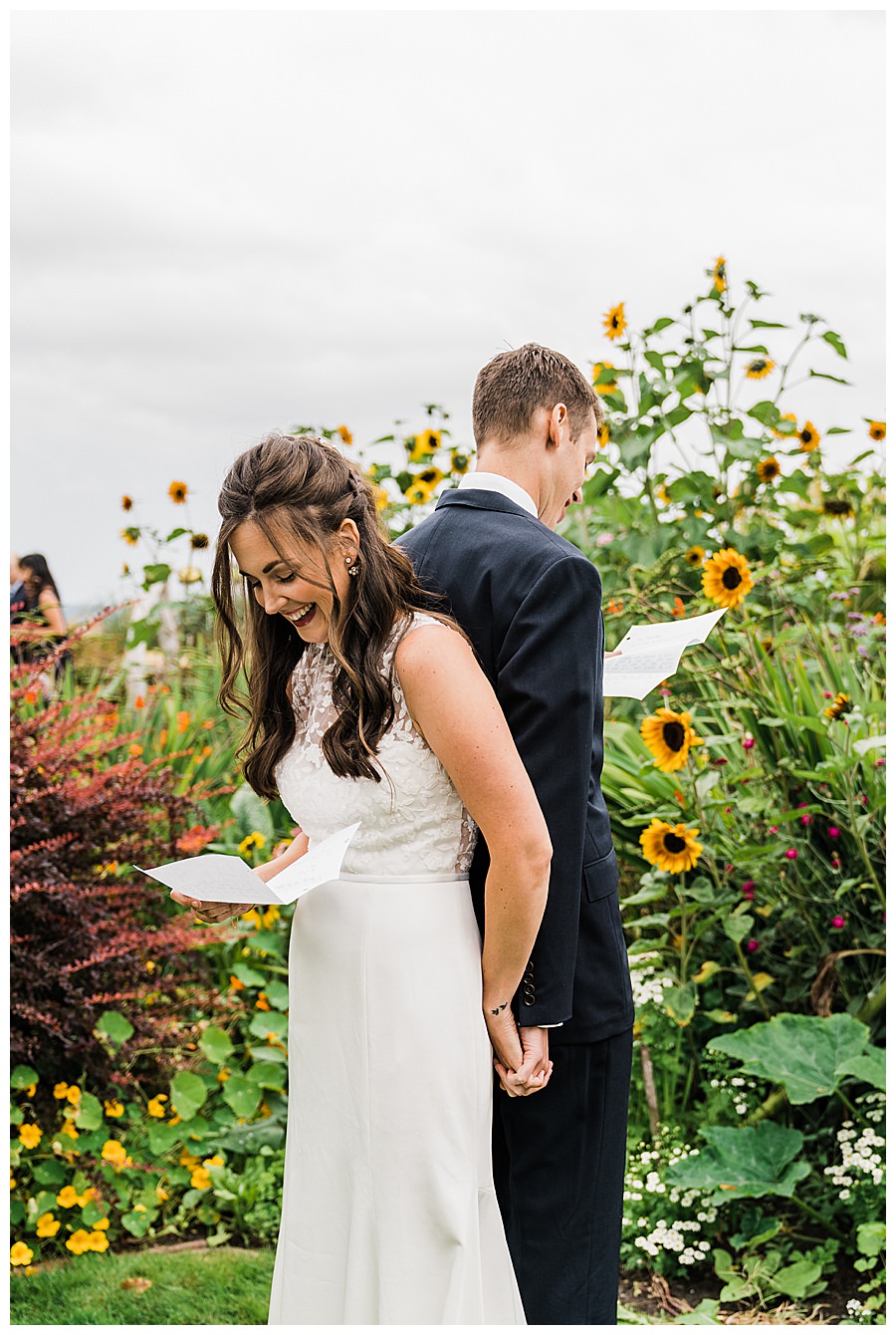 Bride and Groom read each other vows standing back-to-back before they see each other at their Camano Island elopement