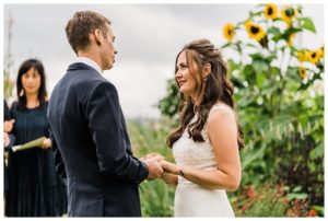 A bride reads her vows to her groom during their Camano Island elopement photographed by Amy Galbraith