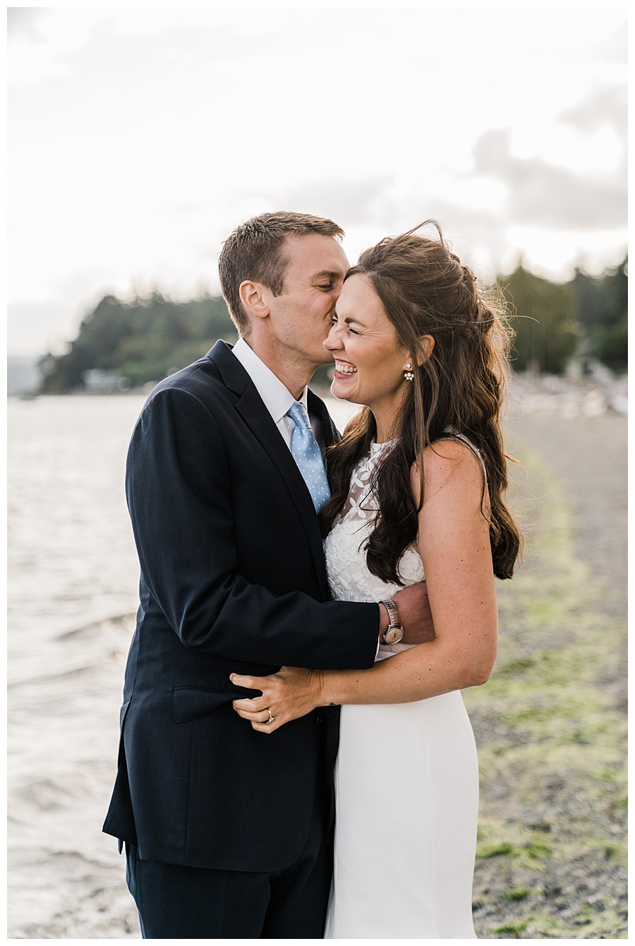 A groom kisses his bride during their Camano Island elopement photographed by Amy Galbraith
