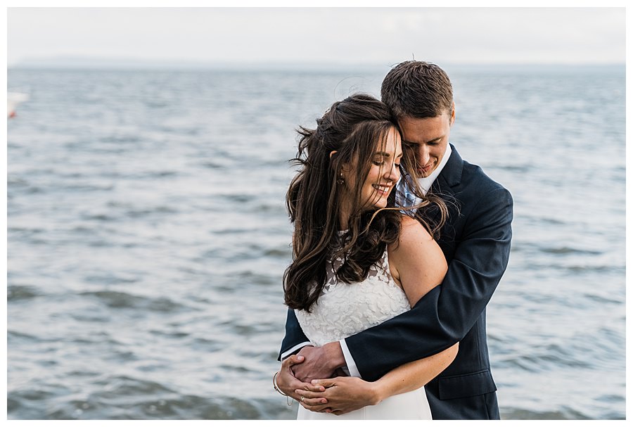 A bride and groom embrace after their Camano Island elopement photographed by Amy Galbraith