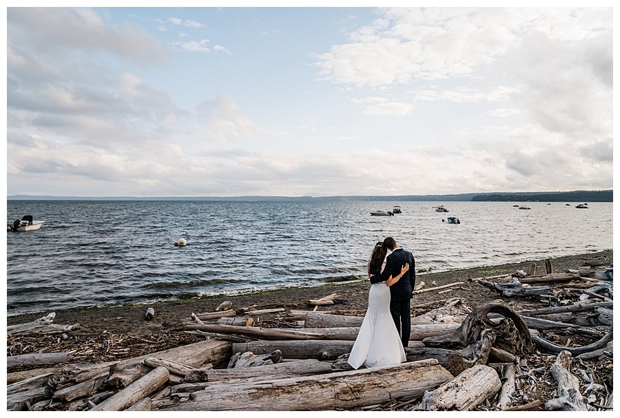 A bride and groom enjoy the view from their Camano Island elopement photographed by Amy Galbraith
