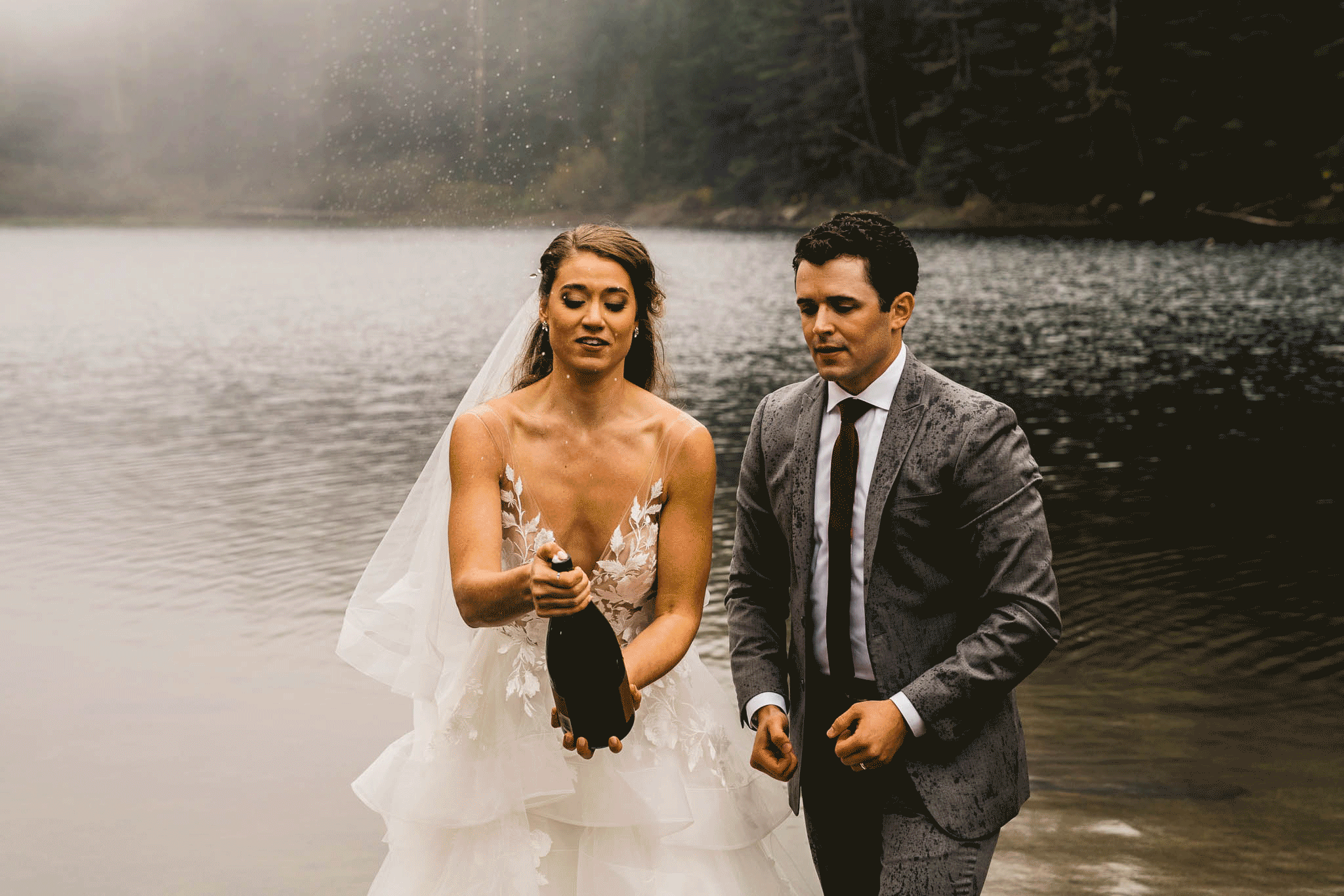 A bride sprays champagne and it accidentally sprays the groom in his face