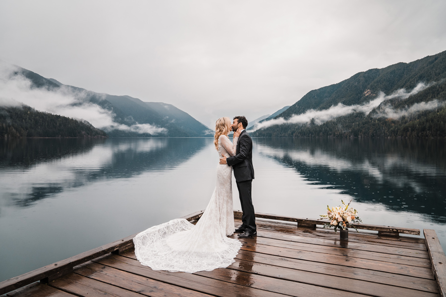 A couple shares in their first kiss after their small elopement ceremony on Lake Crescent in Olympic National Park.
