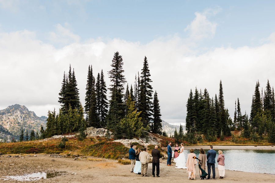 A small elopement ceremony takes place next to a backcountry lake along the Pacific Crest Trail in Washington near Mt Rainier