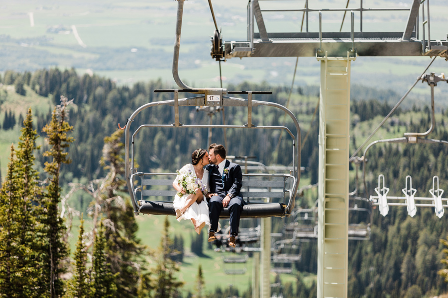 A bride and groom ride the chairlift at Grand Targhee Resort on their wedding day