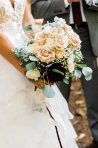 A bridal bouquet of peach roses and eucalyptus greenery