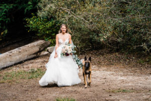A bride walks down the aisle to her ceremony during her hiking elopement in the Cascades