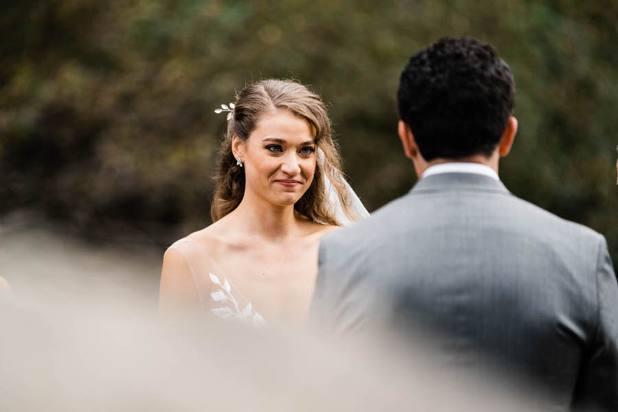 A bride smiles at her groom during their elopement ceremony