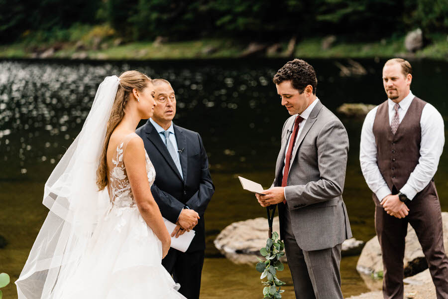 A groom reads his vows to his bride during their elopement ceremony