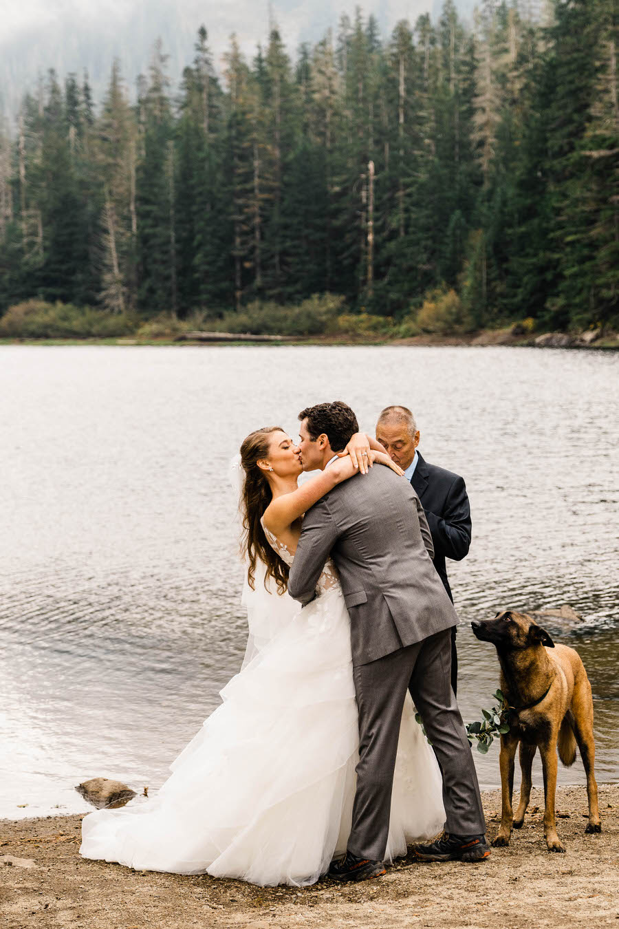 A bride and groom share their first kiss during their hiking elopement ceremony in the Washington Cascades