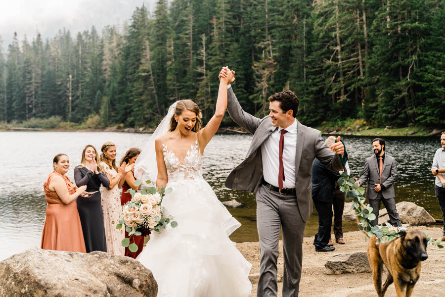 A bride and groom celebrate after their hiking elopement ceremony in the Washington Cascades