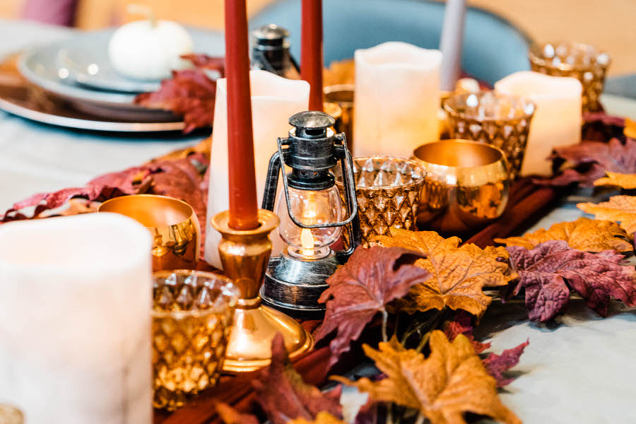 An autumn elopement tablescape with lanterns and fall leaves