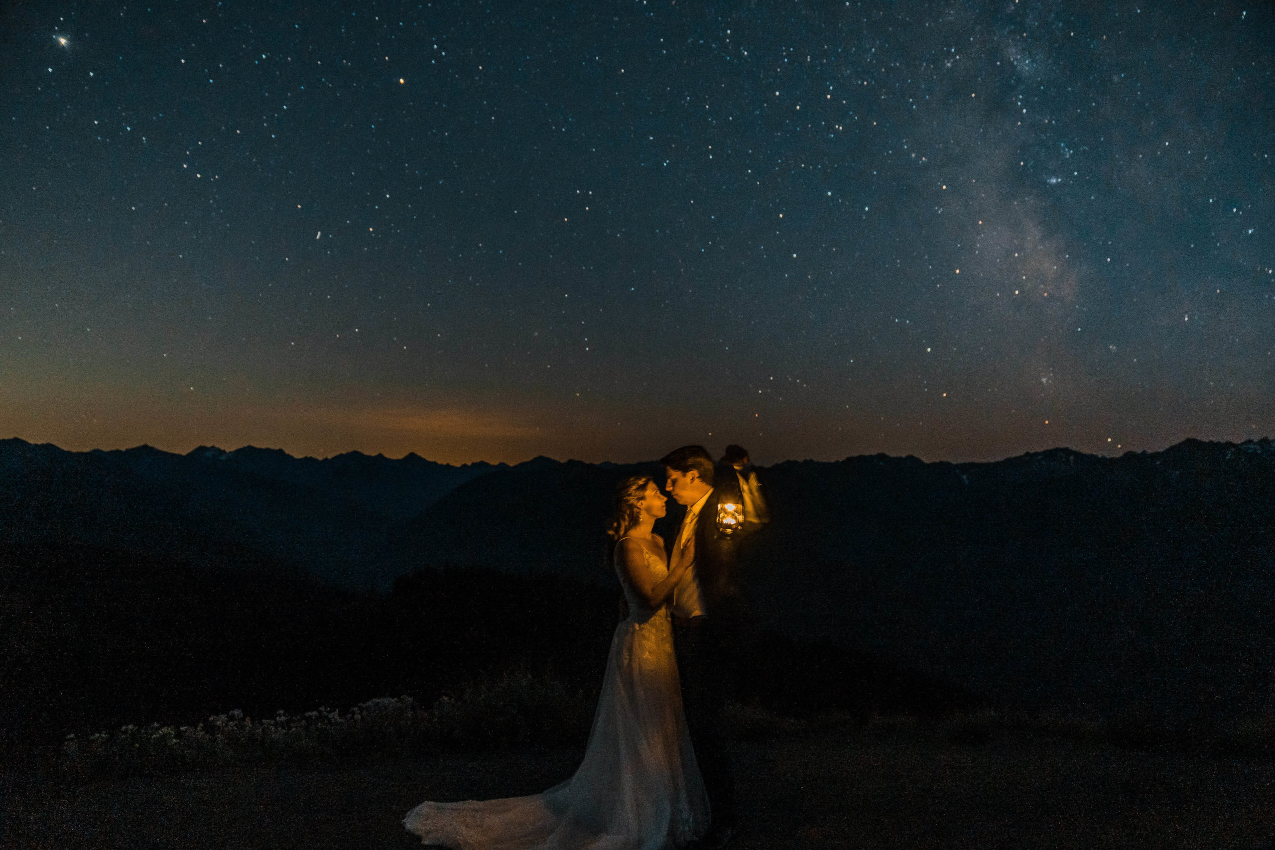 Bride and groom holding lanterns in the dark for their Hurricane Ridge Elopement