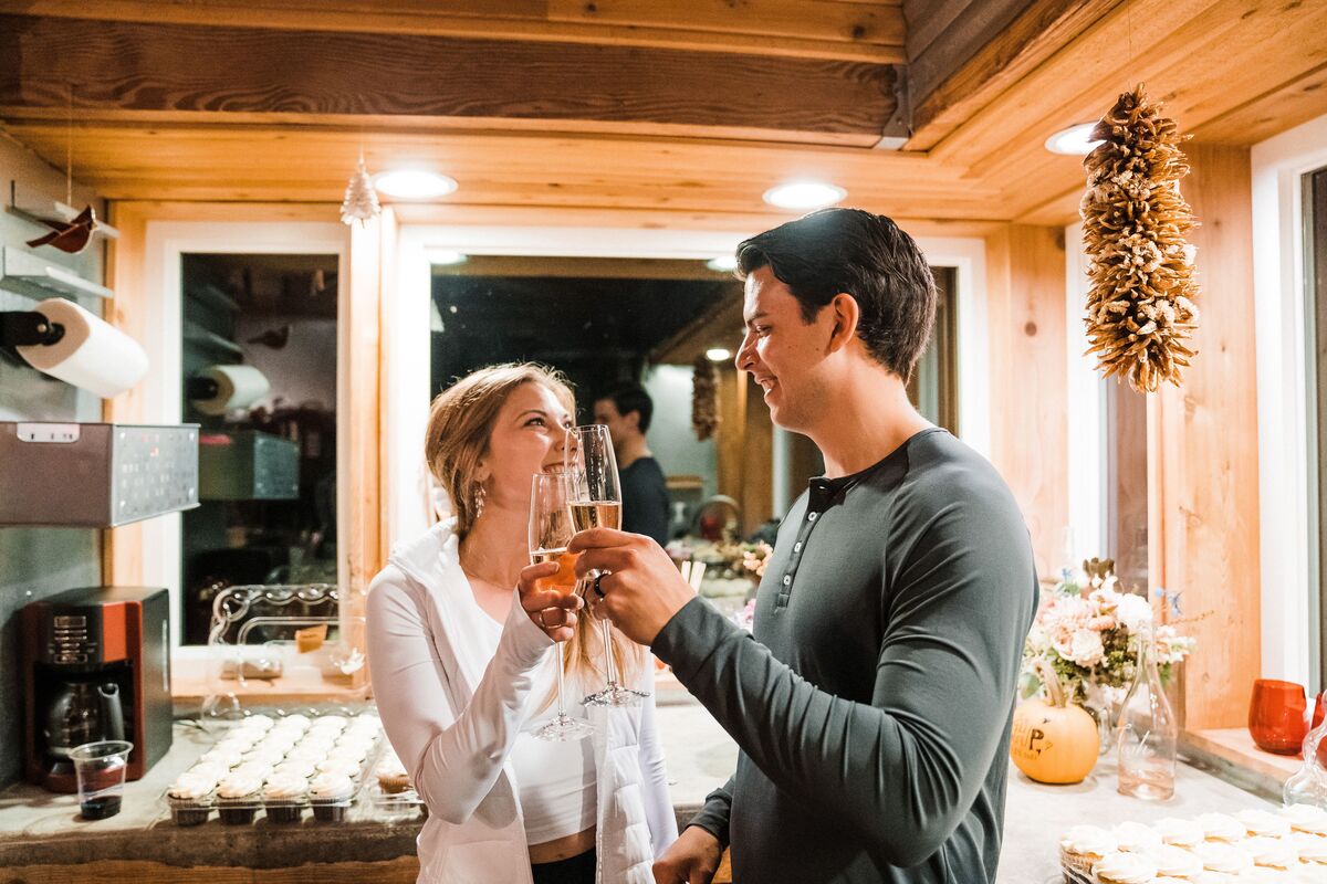 Bride and groom drinking champagne in an Airbnb kitchen