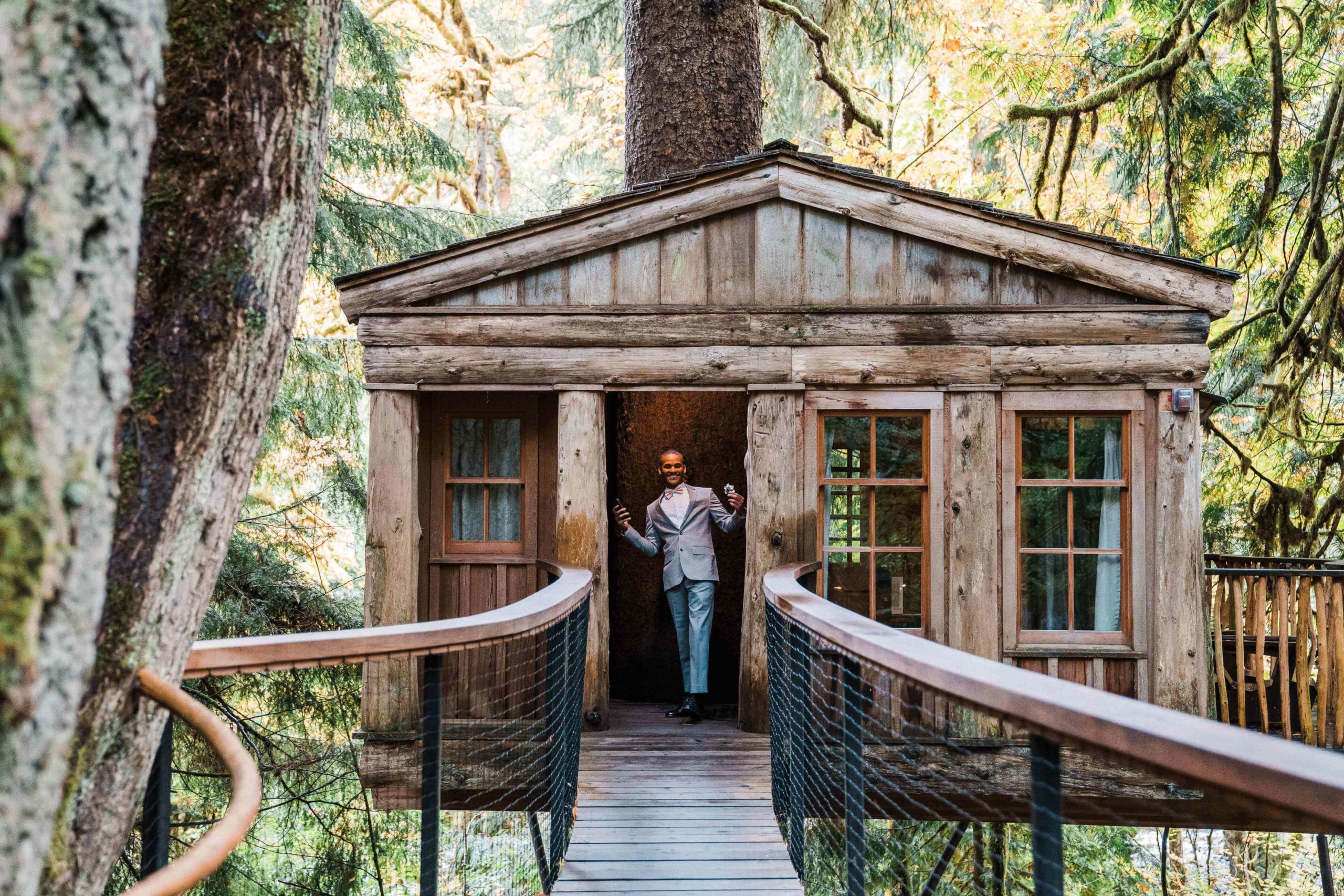 Groom exiting a cabin at treehouse point