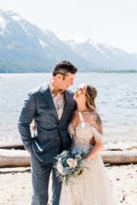 Bride and groom portraits by the water at Washington mountain wedding
