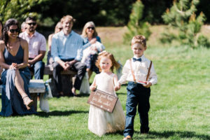 Flower girl and ring bearer walking down the aisle at homestead wedding