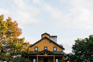 Yellow home in the country serving as a backyard wedding venue